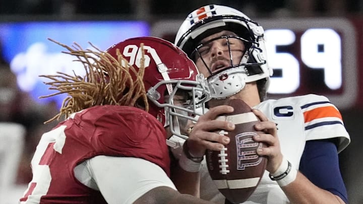 Nov 30, 2024; Tuscaloosa, Alabama, USA;  Alabama Crimson Tide defensive lineman Tim Keenan III (96) hits Auburn Tigers quarterback Payton Thorne (1)  for a loss during the second half at Bryant-Denny Stadium. Alabama won 28-14. Mandatory Credit: Gary Cosby Jr.-Imagn Images