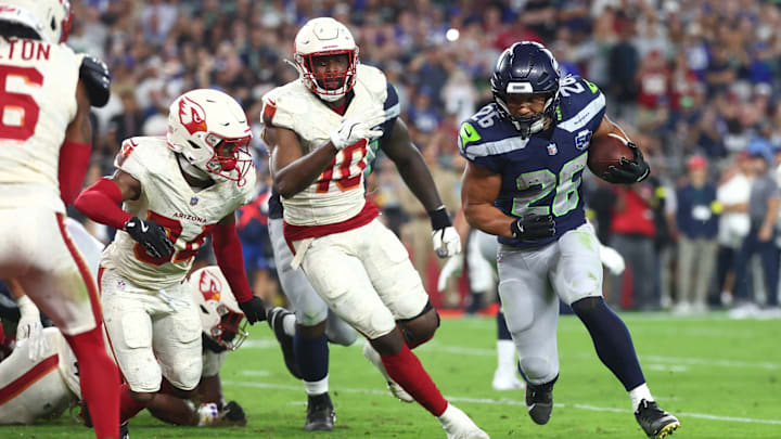 Sep 25, 2025; Glendale, Arizona, USA; Seattle Seahawks running back Zach Charbonnet (26) runs for a touchdown against Arizona Cardinals linebacker Josh Sweat (10) and at State Farm Stadium. Sep 25, 2025; Glendale, Arizona, USA; Seattle Seahawks running back Zach Charbonnet (26) runs for a touchdown against Arizona Cardinals linebacker Josh Sweat (10) and at State Farm Stadium.