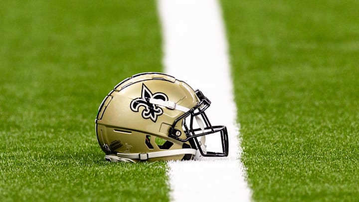 Aug 25, 2024; New Orleans, Louisiana, USA;  New Orleans Saints helmet on the turf during warmups before the game against the Tennessee Titans at Caesars Superdome. Mandatory Credit: Stephen Lew-Imagn Images