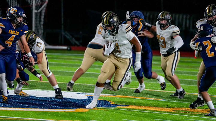 Junior running back Nickolas Stafford (1) runs the ball for the North Kingstown football team.