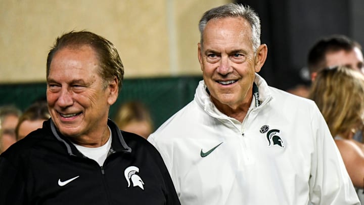 Former Michigan State head coach Mark Dantonio, right, and Tom Izzo stand on the sidelines after Dantonio was recognized for his induction to the National Football Foundation Hall of Fame and for his addition to the the Spartans Ring of Fame during MSU's game against Ohio State on Saturday, Sept. 28, 2024, at Spartan Stadium in East Lansing.