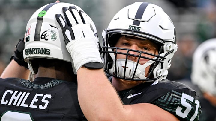 Michigan State's Matt Gulbin, right, hugs quarterback Aidan Chiles before the football game against Boston College on Saturday, Sept. 6, 2025, at Spartan Stadium in East Lansing.