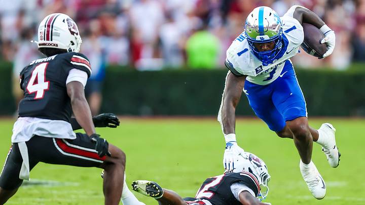 Oct 3, 2026; Columbia, South Carolina, USA;  Kentucky Wildcats running back CJ Baxter (1) is upended by South Carolina Gamecocks defensive back Quay'sheed Scott (12) in the second half at Williams-Brice Stadium.  Mandatory Credit: Jeff Blake-Imagn Images