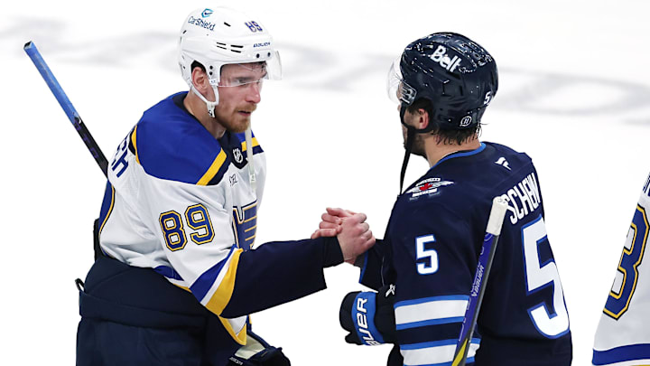 May 4, 2025; Winnipeg, Manitoba, CAN; St. Louis Blues left wing Pavel Buchnevich (89) and Winnipeg Jets defenseman Luke Schenn (5) shake hands after the Winnipeg Jets won in double overtime in game seven of the first round of the 2025 Stanley Cup Playoffs at Canada Life Centre. Mandatory Credit: James Carey Lauder-Imagn Images