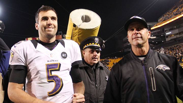 November 18, 2012; Pittsburgh, PA, USA; Baltimore Ravens head coach John Harbaugh (right) and quarterback Joe Flacco (5) react while leaving the field after defeating the Pittsburgh Steelers at Heinz Field. The Baltimore Ravens won 13-10. Mandatory Credit: Charles LeClaire-USA TODAY Sports