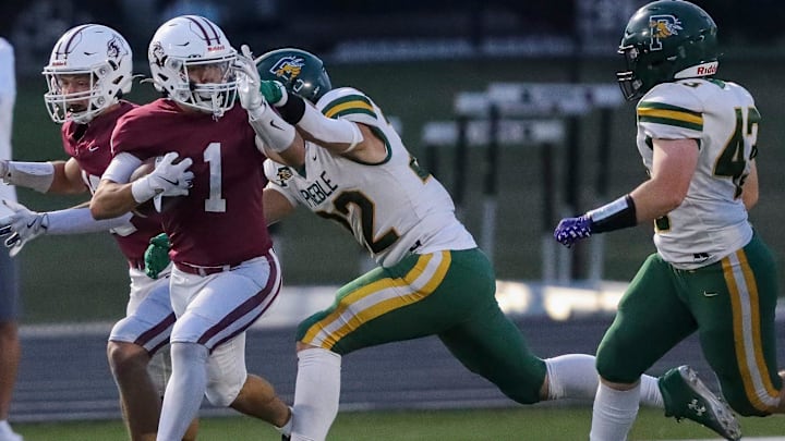 De Pere High School's Dante Matta (1) runs the ball as Green Bay Preble linebacker Nick Zellner (22) attempts to make a tackle during a Fox River Classic Conference (North Division) game on Friday, September 19, 2025. Tork Mason/USA TODAY NETWORK-Wisconsin