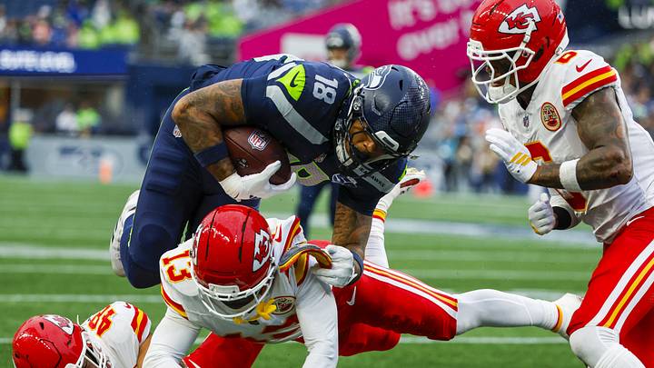 Seattle Seahawks tight end Elijah Arroyo (18) runs for yards after the catch against Kansas City Chiefs safety Nazeeh Johnson (13), linebacker Cole Christiansen (48) and safety Bryan Cook (6). Seattle Seahawks tight end Elijah Arroyo (18) runs for yards after the catch against Kansas City Chiefs safety Nazeeh Johnson (13), linebacker Cole Christiansen (48) and safety Bryan Cook (6).