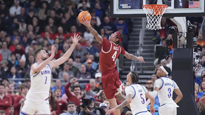 Arkansas Razorbacks forward Trevon Brazile (4) reaches for the ball against Kansas Jayhawks center Hunter Dickinson (1) during the second half at Amica Mutual Pavilion. 