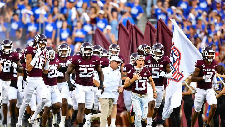 Sep 4, 2021;  College Station, Texas, USA;  Texas A&M Aggies head coach Jimbo Fisher runs out with his team against the Kent State Golden Flashes at Kyle Field. Mandatory Credit: Maria Lysaker-USA TODAY Sports
