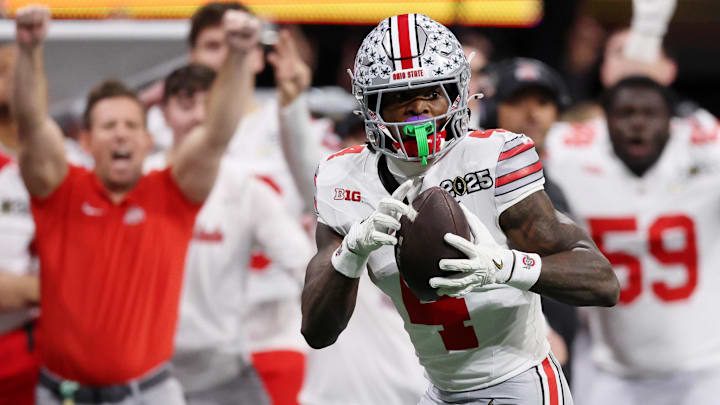 Jan 20, 2025; Atlanta, GA, USA; Ohio State Buckeyes wide receiver Jeremiah Smith (4) makes a catch against the Notre Dame Fighting Irish during the second half the CFP National Championship college football game at Mercedes-Benz Stadium. Mandatory Credit: Brett Davis-Imagn Images