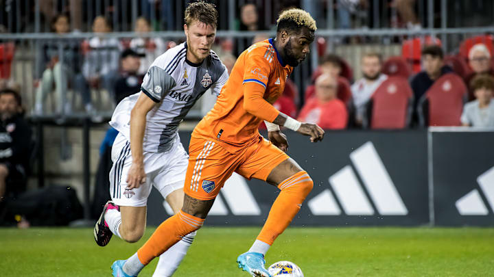 Aaron Boupendza #9 (R) of FC Cincinnati and Sigurd Rosted #...