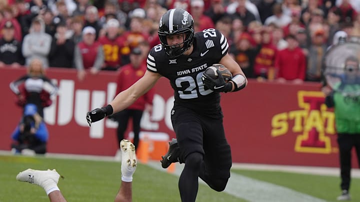 Iowa State Cyclones' running back Carson Hansen (26) runs with the ball as BYU Cougars linebacker Max Alford (30) misses the tackle during the first quarter at Jack Trice Stadium on Oct. 25, 2025, in Ames, Iowa. Iowa State Cyclones' running back Carson Hansen (26) runs with the ball as BYU Cougars linebacker Max Alford (30) misses the tackle during the first quarter at Jack Trice Stadium on Oct. 25, 2025, in Ames, Iowa.