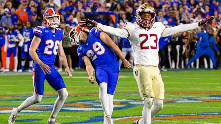 Florida Gators place kicker Trey Smack (29) reacts to a missed field goal in the final seconds of the first half as Florida State Seminoles defensive back Fentrell Cypress II (23) signals a miss at Steve Spurrier Field at Ben Hill Griffin Stadium in Gainesville, FL on Saturday, November 25, 2023. [Doug Engle/Gainesville Sun]