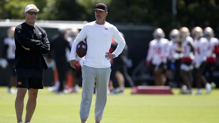 Jun 11, 2025; Santa Clara, CA, USA; San Francisco 49ers head coach Kyle Shanahan (right) watches his players work out during a team OTA at Levi's Stadium. Mandatory Credit: D. Ross Cameron-Imagn Images Jun 11, 2025; Santa Clara, CA, USA; San Francisco 49ers head coach Kyle Shanahan (right) watches his players work out during a team OTA at Levi's Stadium. Mandatory Credit: D. Ross Cameron-Imagn Images