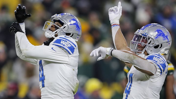 Former Detroit Lions wide receivers DJ Chark (4) and Amon-Ra St. Brown (14) celebrate at Lambeau Field.