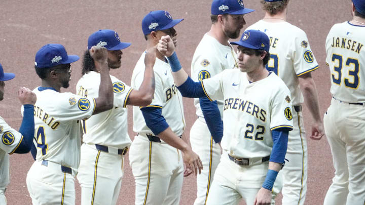 Oct 13, 2025; Milwaukee, Wisconsin, USA; Milwaukee Brewers left fielder Christian Yelich (22) greets teammates during player introduction prior to game one of the NLCS round against the Los Angeles Dodgers for the 2025 MLB playoffs at American Family Field. Mandatory Credit: Michael McLoone-Imagn Images
