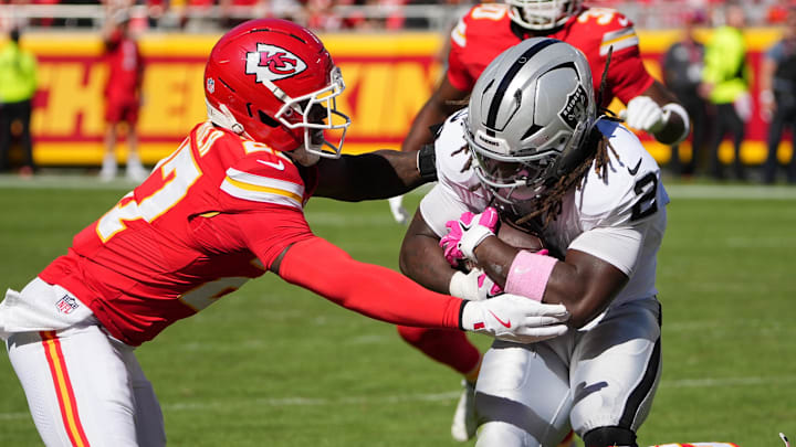 Oct 19, 2025; Kansas City, Missouri, USA; Kansas City Chiefs defensive back Chamarri Conner (27) tackles Las Vegas Raiders running back Ashton Jeanty (2) during the third quarter of the game at GEHA Field at Arrowhead Stadium. Mandatory Credit: Denny Medley-Imagn Images