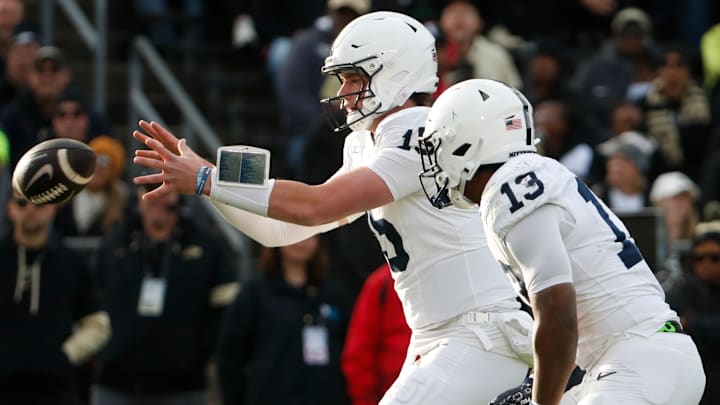 Penn State Nittany Lions quarterback Drew Allar (15) takes a snap next to running back Kaytron Allen in a game against the Purdue Boilermakers at Ross-Ade Stadium.