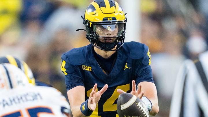 Michigan Wolverines quarterback Tommy Carr (14) receives the ball in the fourth quarter of a game against UTEP at Michigan Stadium in Ann Arbor on Saturday, Sept. 19, 2026.