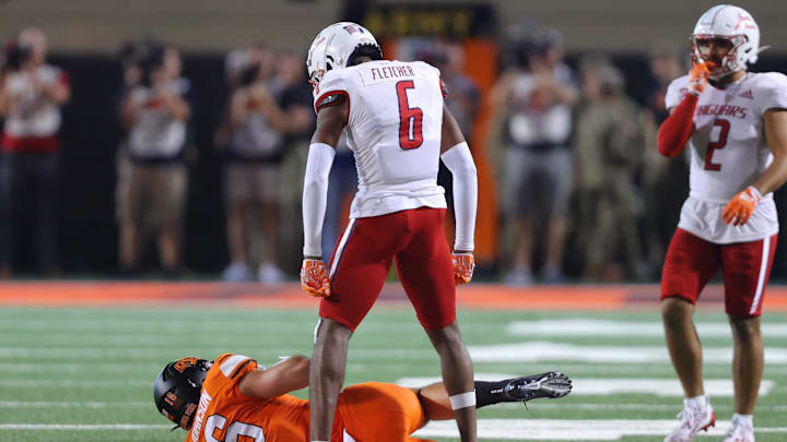Sep 16, 2023; Stillwater, Oklahoma, USA; South Alabama Jaguars cornerback Ricky Fletcher (6) celebrates over Oklahoma State Cowboys tight end Josiah Johnson (16)  during an NCAA football game between Oklahoma State and South Alabama at Boone Pickens Stadium. South Alabama won 33-7. Mandatory Credit: Bryan Terry-Imagn Images