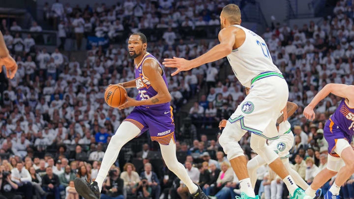 Apr 23, 2024; Minneapolis, Minnesota, USA; Phoenix Suns forward Kevin Durant (35) dribbles against Minnesota Timberwolves center Rudy Gobert (27) in the second quarter during game two of the first round for the 2024 NBA playoffs at Target Center. Mandatory Credit: Brad Rempel-USA TODAY Sports