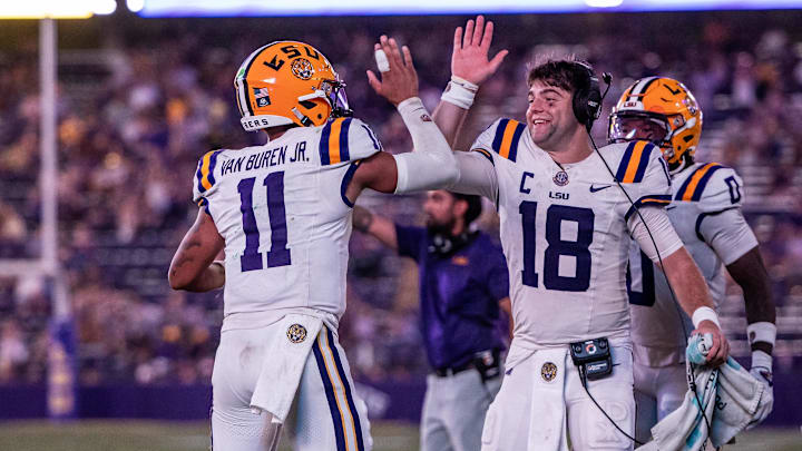 Sep 20, 2025; Baton Rouge, Louisiana, USA; LSU Tigers quarterback Garrett Nussmeier (18) congratulates LSU Tigers quarterback Michael Van Buren Jr. (11) on a touchdown run against the Southeastern Louisiana Lions during the second half at Tiger Stadium. Mandatory Credit: Stephen Lew-Imagn Images Sep 20, 2025; Baton Rouge, Louisiana, USA; LSU Tigers quarterback Garrett Nussmeier (18) congratulates LSU Tigers quarterback Michael Van Buren Jr. (11) on a touchdown run against the Southeastern Louisiana Lions during the second half at Tiger Stadium. Mandatory Credit: Stephen Lew-Imagn Images