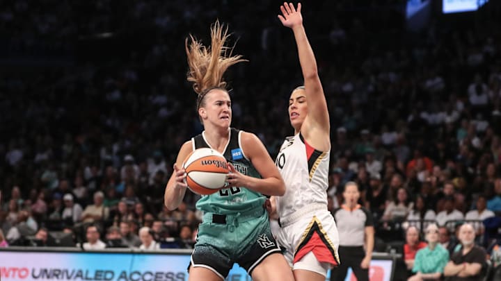 New York Liberty guard Sabrina Ionescu (20) looks to post up Kelsey Plum.
