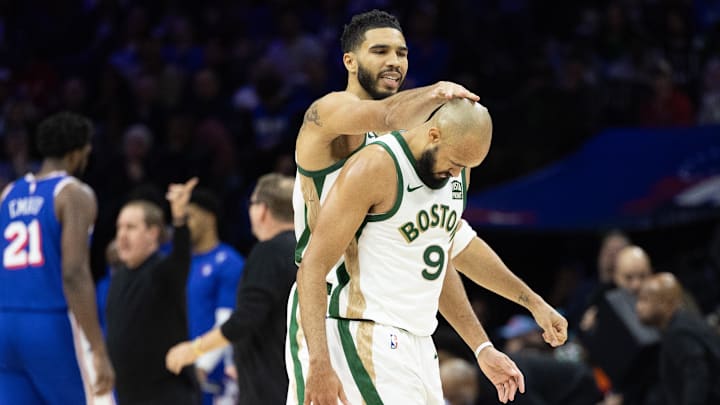 Nov 15, 2023; Philadelphia, Pennsylvania, USA; Boston Celtics forward Jayson Tatum (0) congratulates guard Derrick White (9) after his three pointer against the Philadelphia 76ers during the fourth quarter at Wells Fargo Center. Mandatory Credit: Bill Streicher-Imagn Images