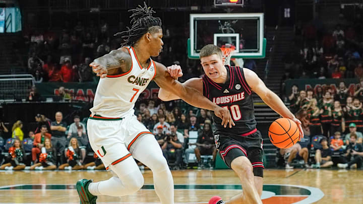 Mar 7, 2026; Coral Gables, Florida, USA; Louisville Cardinals guard Isaac McKneely (10) dribbles the ball against Miami Hurricanes forward Shelton Henderson (7) at Watsco Center. Mandatory Credit: Jeff Romance-Imagn Images