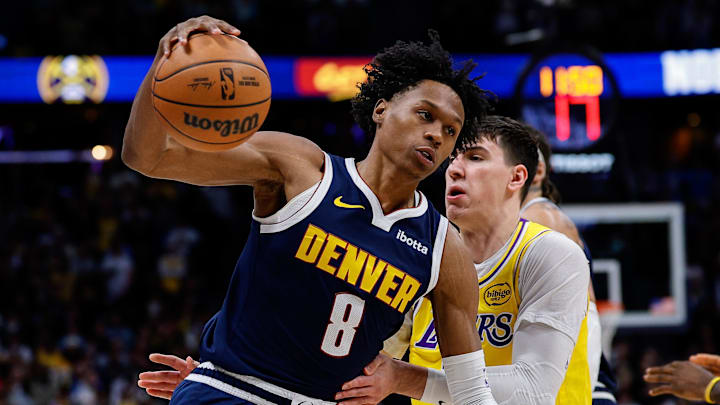 Jan 20, 2026; Denver, Colorado, USA; Denver Nuggets guard Peyton Watson (8) controls the ball under pressure from Los Angeles Lakers forward Jake LaRavia (12) in the first quarter at Ball Arena. Mandatory Credit: Isaiah J. Downing-Imagn Images