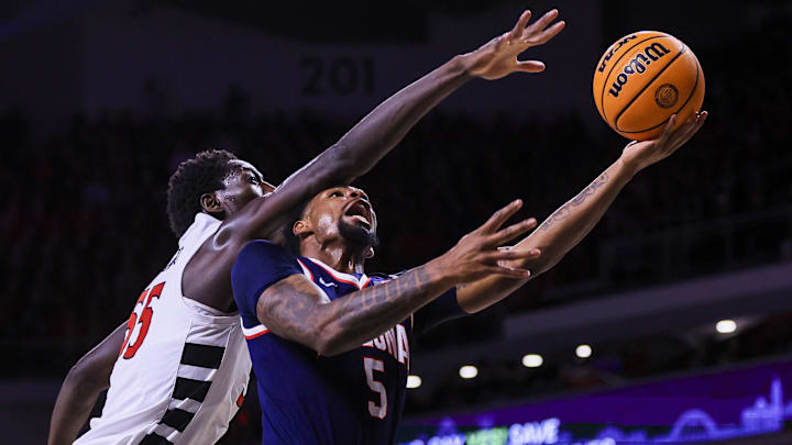 Jan 4, 2025; Cincinnati, Ohio, USA; Arizona Wildcats guard KJ Lewis (5) shoots against Cincinnati Bearcats forward Aziz Bandaogo (55) in the first half at Fifth Third Arena. Mandatory Credit: Katie Stratman-Imagn Images Jan 4, 2025; Cincinnati, Ohio, USA; Arizona Wildcats guard KJ Lewis (5) shoots against Cincinnati Bearcats forward Aziz Bandaogo (55) in the first half at Fifth Third Arena. Mandatory Credit: Katie Stratman-Imagn Images