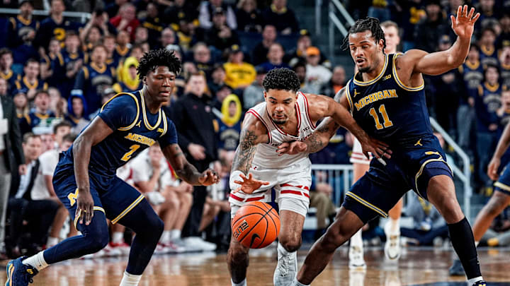 Michigan guard L.J.Cason (2) and guard Roddy Gayle Jr. (11) defend Wisconsin guard Nick Boyd (2) during the second half at Crisler Center in Ann Arbor on Saturday, Jan. 10, 2026.