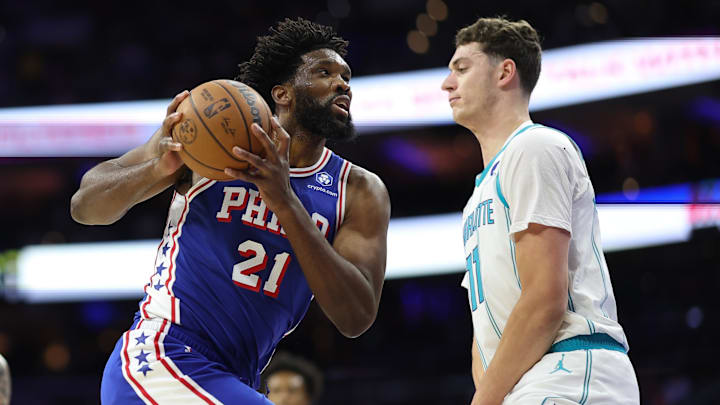 Oct 25, 2025; Philadelphia, Pennsylvania, USA; Philadelphia 76ers center Joel Embiid (21) drives against Charlotte Hornets center Ryan Kalkbrenner (11) during the first quarter at Xfinity Mobile Arena. Oct 25, 2025; Philadelphia, Pennsylvania, USA; Philadelphia 76ers center Joel Embiid (21) drives against Charlotte Hornets center Ryan Kalkbrenner (11) during the first quarter at Xfinity Mobile Arena.