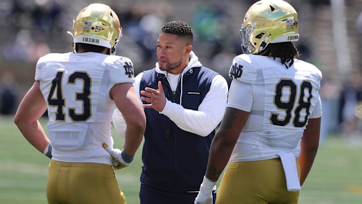 Notre Dame Head Coach Marcus Freeman speaks to Kahanu Kia (43) and Devan Houstan (98) Saturday, April 20, 2024, at the annual Notre Dame Blue-Gold spring football game at Notre Dame Stadium in South Bend.