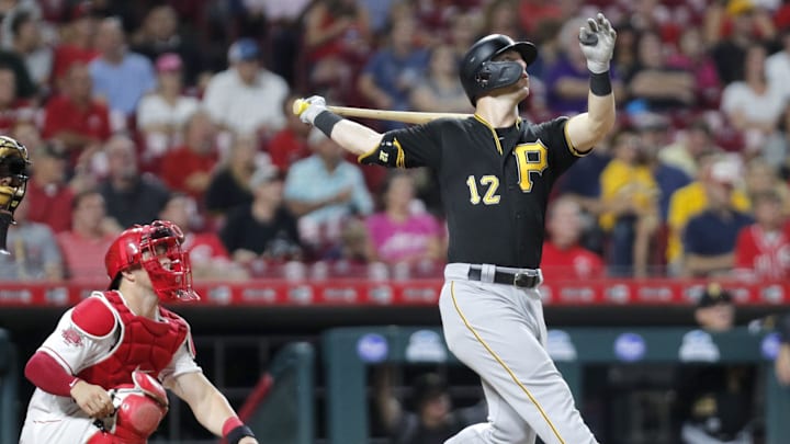 Jul 30, 2019; Cincinnati, OH, USA; Pittsburgh Pirates left fielder Corey Dickerson (12) follows through on a swing for a solo home run against the Cincinnati Reds during the seventh inning at Great American Ball Park. Mandatory Credit: David Kohl-Imagn Images