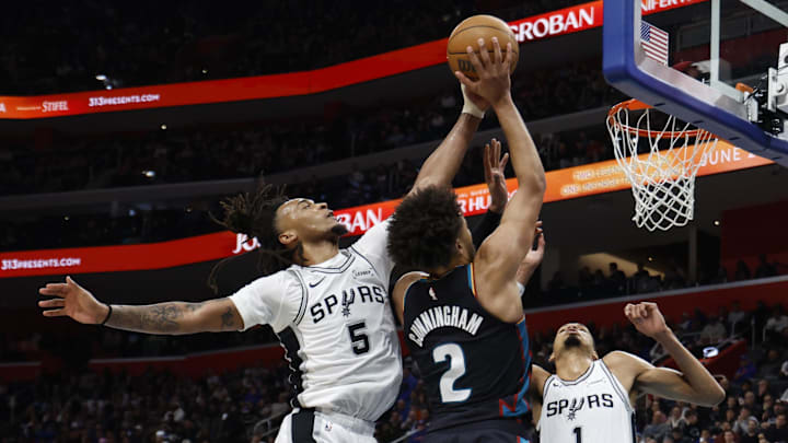 Feb 23, 2026; Detroit, Michigan, USA;  San Antonio Spurs guard Stephon Castle (5) blocks a shot by Detroit Pistons guard Cade Cunningham (2) in the second half at Little Caesars Arena. Mandatory Credit: Rick Osentoski-Imagn Images