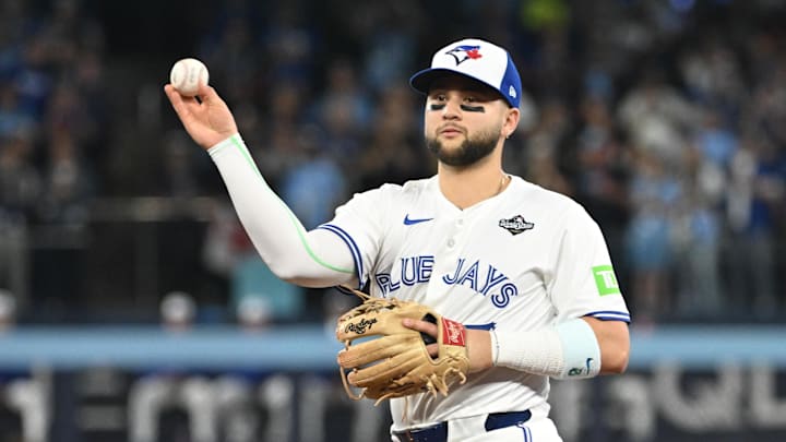 Oct 24, 2025; Toronto, Ontario, CAN; Toronto Blue Jays second baseman Bo Bichette (11) makes a play to get out Los Angeles Dodgers first baseman Freddie Freeman (not pictured) in the first inning during game one of the 2025 MLB World Series at Rogers Centre. Mandatory Credit: Dan Hamilton-Imagn Images