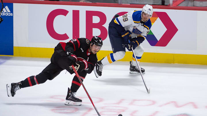 Mar 21, 2024; Ottawa, Ontario, CAN; Ottawa Senators defenseman Thomas Chabot (72) moves the puck away from St. Louis Blues left wing Pavel Buchnevich (89) in the third period at the Canadian Tire Centre. Mandatory Credit: Marc DesRosiers-Imagn Images