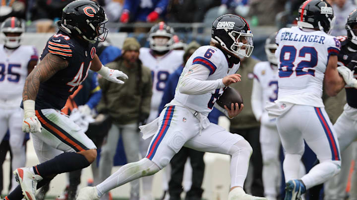 Jaxson Dart takes off with the football on a planned QB run as Noah Sewell gives chase in Sunday's 24-20 Bears win.