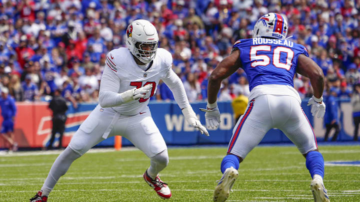 Sep 8, 2024; Orchard Park, New York, USA; Arizona Cardinals offensive tackle Paris Johnson Jr. (70) looks to block Buffalo Bills defensive end Greg Rousseau (50) during the first half at Highmark Stadium. Mandatory Credit: Gregory Fisher-Imagn Images