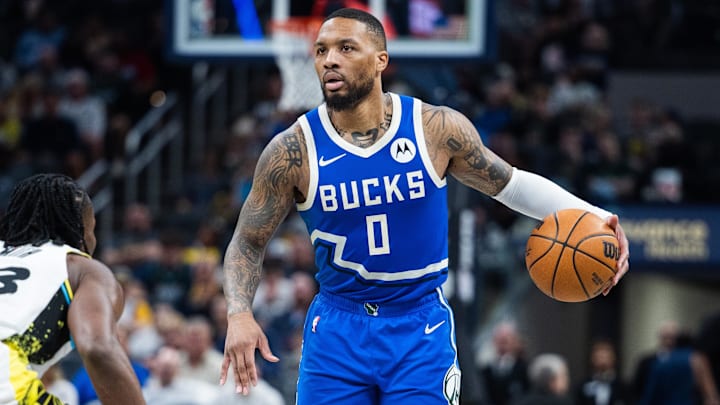 Mar 11, 2025; Indianapolis, Indiana, USA; Milwaukee Bucks guard Damian Lillard (0) dribbles the ball while Indiana Pacers forward Aaron Nesmith (23) defends in the second half  at Gainbridge Fieldhouse. Mandatory Credit: Trevor Ruszkowski-Imagn Images