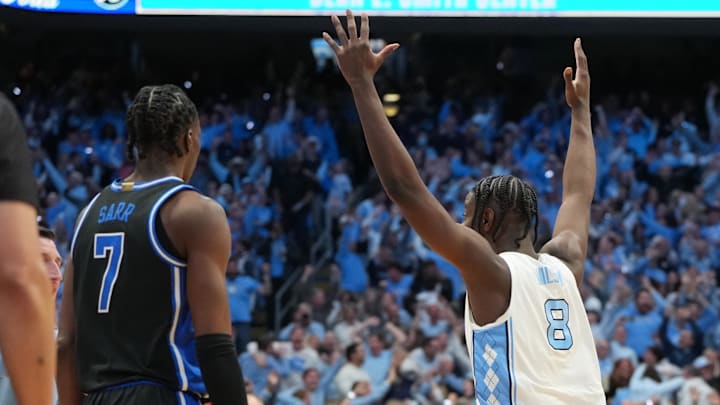 Feb 7, 2026; Chapel Hill, North Carolina, USA; Duke Blue Devils guard Dame Sarr (7) and North Carolina Tar Heels forward Caleb Wilson (8) react in the second half at Dean E. Smith Center.