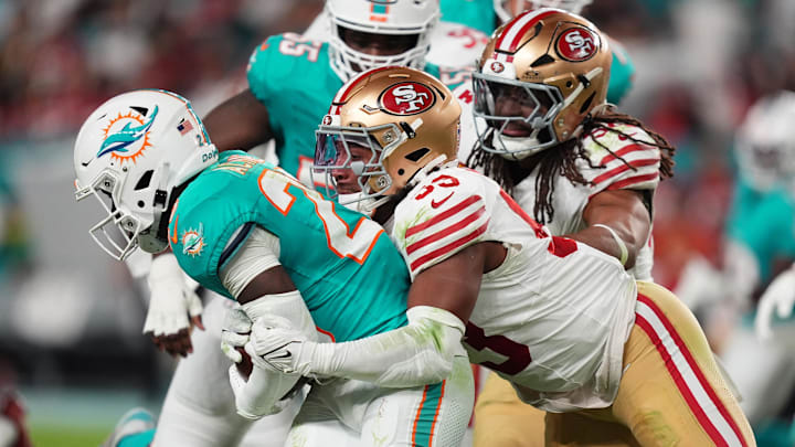 San Francisco 49ers linebacker Dee Winters (53) tackles Miami Dolphins running back De'Von Achane (28) during second half at Hard Rock Stadium.