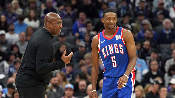 Nov 16, 2024; Sacramento, California, USA; Sacramento Kings head coach Mike Brown (left) talks with guard De'Aaron Fox (5) during the second quarter against the Utah Jazz at Golden 1 Center. Mandatory Credit: Darren Yamashita-Imagn Images