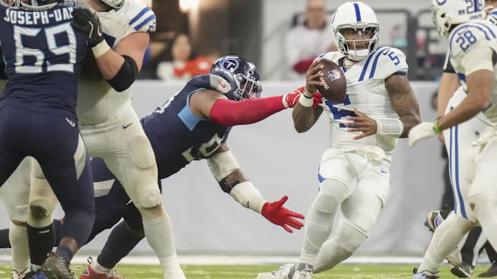 Dec 22, 2024; Indianapolis, Indiana, USA; Indianapolis Colts quarterback Anthony Richardson (5) is sacked by Tennessee Titans defensive tackle Jeffery Simmons (98) during a game against the Tennessee Titans at Lucas Oil Stadium. Mandatory Credit: Christine Tannous/USA Today Network via Imagn Images 