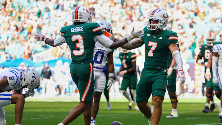 Nov 2, 2024; Miami Gardens, Florida, USA; Miami Hurricanes wide receiver Xavier Restrepo (7) celebrates with wide receiver Jacolby George (3) after scoring a touchdown against the Duke Blue Devils during the third quarter at Hard Rock Stadium. Mandatory Credit: Sam Navarro-Imagn Images