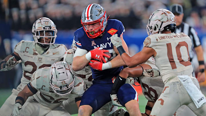 Dec 11, 2021; East Rutherford, New Jersey, USA; Navy Midshipmen fullback Isaac Ruoss (32) carries the ball against the Army Black Knights during the second half of the 122nd Army-Navy game.