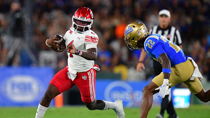 Aug 30, 2025; Pasadena, California, USA; Utah Utes quarterback Devon Dampier (4) runs the ball against UCLA Bruins defensive back Croix Stewart (22) during the first half at Rose Bowl. Mandatory Credit: Gary A. Vasquez-Imagn Images