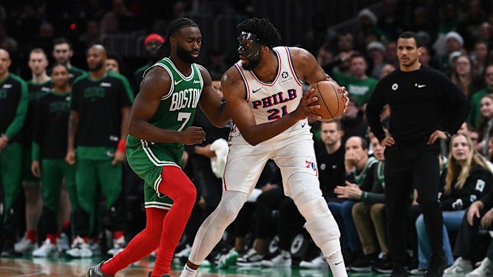 Dec 25, 2024; Boston, Massachusetts, USA; Philadelphia 76ers center Joel Embiid (21) holds the ball against Boston Celtics guard Jaylen Brown (7) during the second half at TD Garden. Mandatory Credit: Eric Canha-Imagn Images