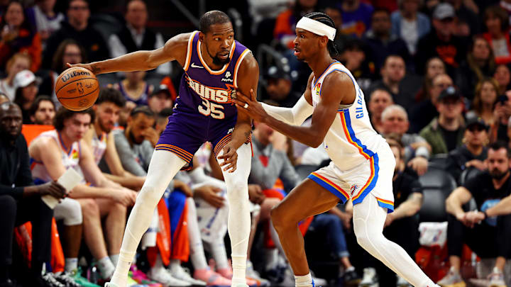 Mar 3, 2024; Phoenix, Arizona, USA; Phoenix Suns forward Kevin Durant (35) handles the ball against Oklahoma City Thunder guard Shai Gilgeous-Alexander (2) during the second quarter at Footprint Center. Mandatory Credit: Mark J. Rebilas-Imagn Images